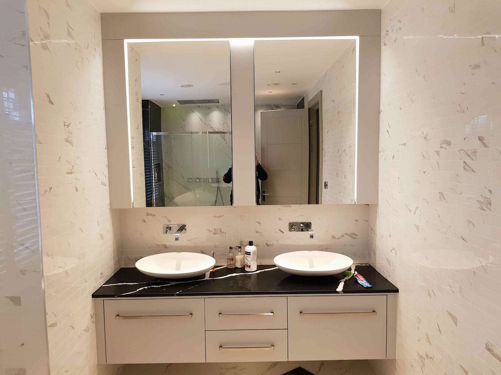Marble vanity with backlit mirror, by Briland Demja