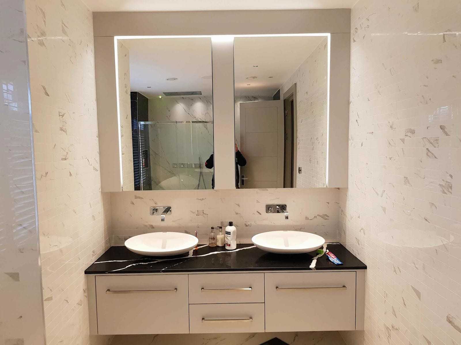 Marble vanity with backlit mirror, by Briland Demja